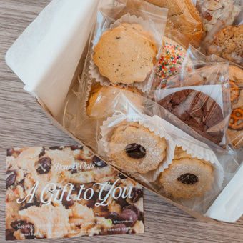 Box of assorted cookies with a 'Gift to you' card.