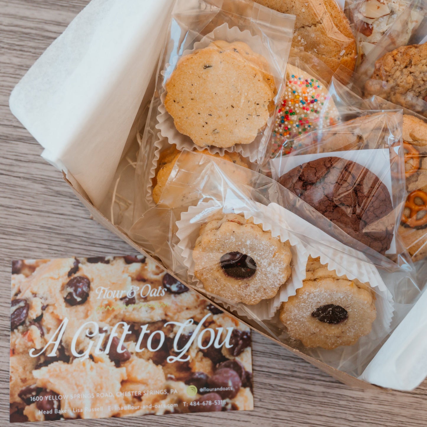 Box of assorted cookies with a 'Gift to you' card.